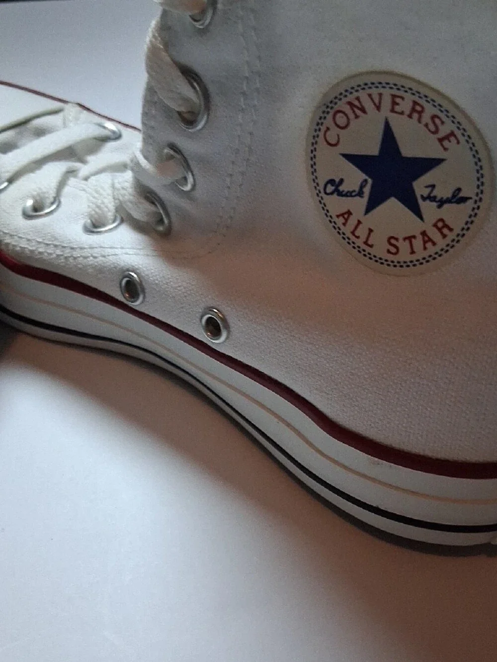 Converse white high-top sneakers with red trim